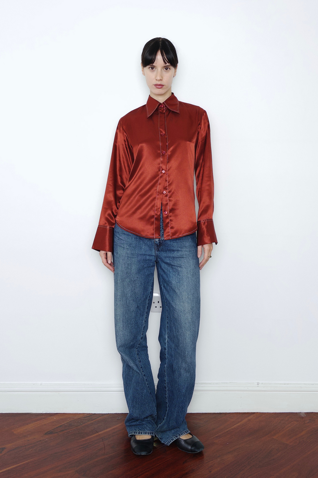 rust silk shirt with contrast stitching with a statement collar and cuffs