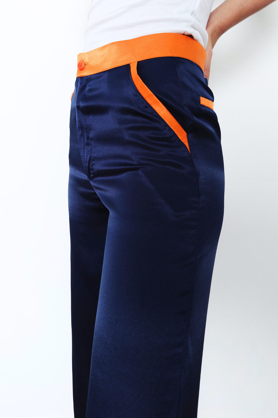 navy silk trousers, wide-leg, with orange contrast trims worn in London