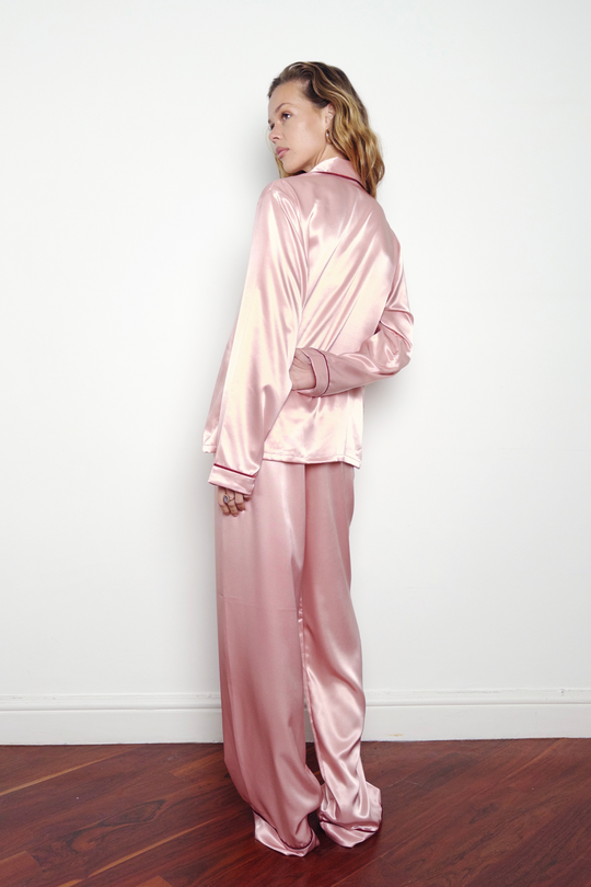 Pink silk matching pyjamas with red piping, worn in London