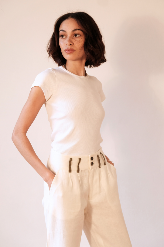 White pure linen trousers with khaki detailing, worn in London