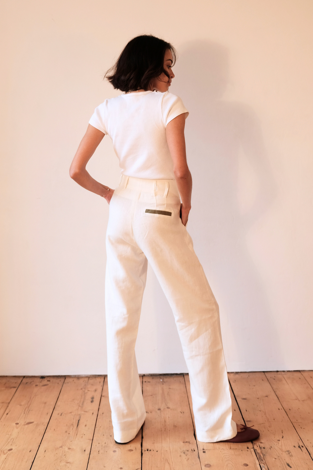 White pure linen trousers with khaki detailing, worn in London