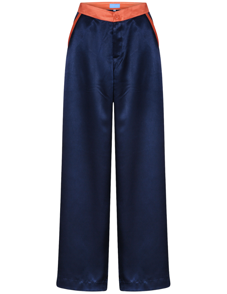 navy silk trousers, wide-leg, with orange contrast trims worn in London