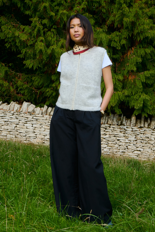 Light grey sleeveless knit vest with zip front and patch pockets