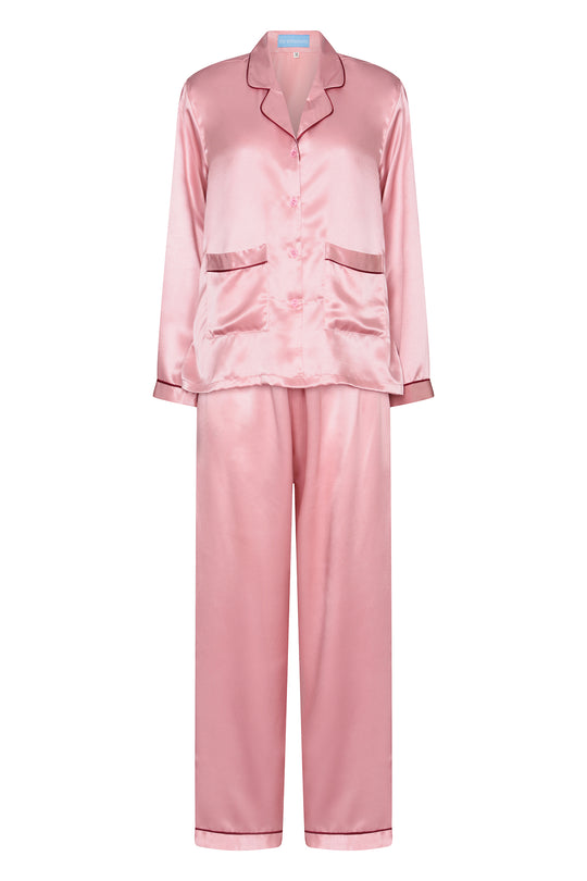 Pink silk matching pyjamas with red piping, worn in London