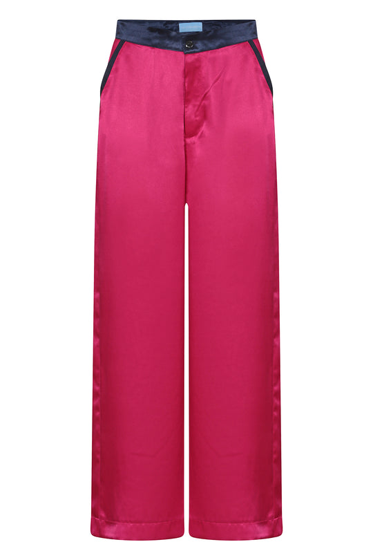 dark pink wide-leg silk trousers with navy trims, worn in London